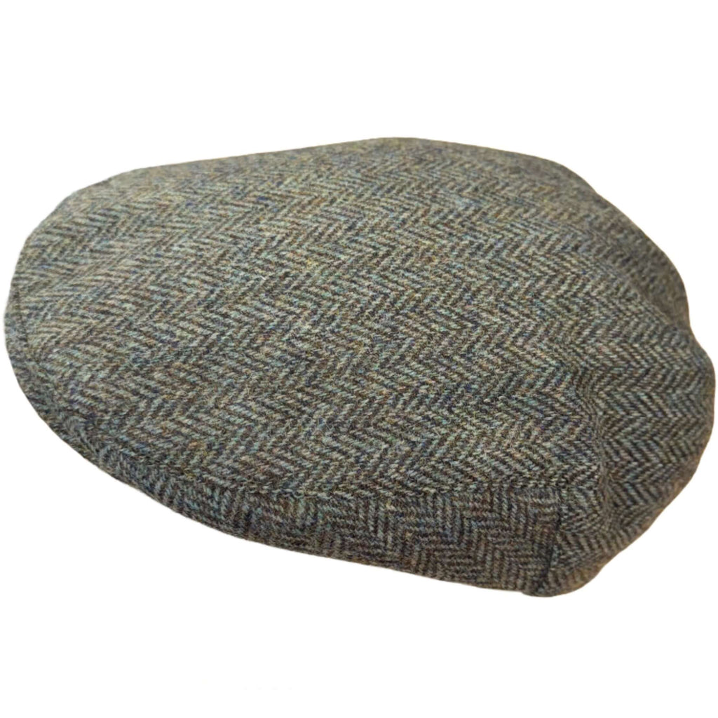 Magee Donegal Tweed Flat Cap in green herringbone, angled view